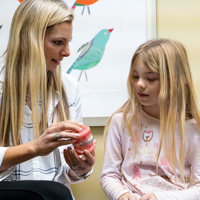 Girl with metal braces in orthodontist office with Dr. Laura Parrish